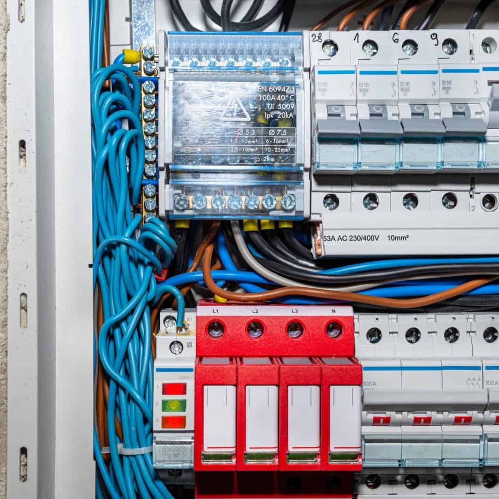 Electrical panel with circuit breakers and wiring for electrical services.
